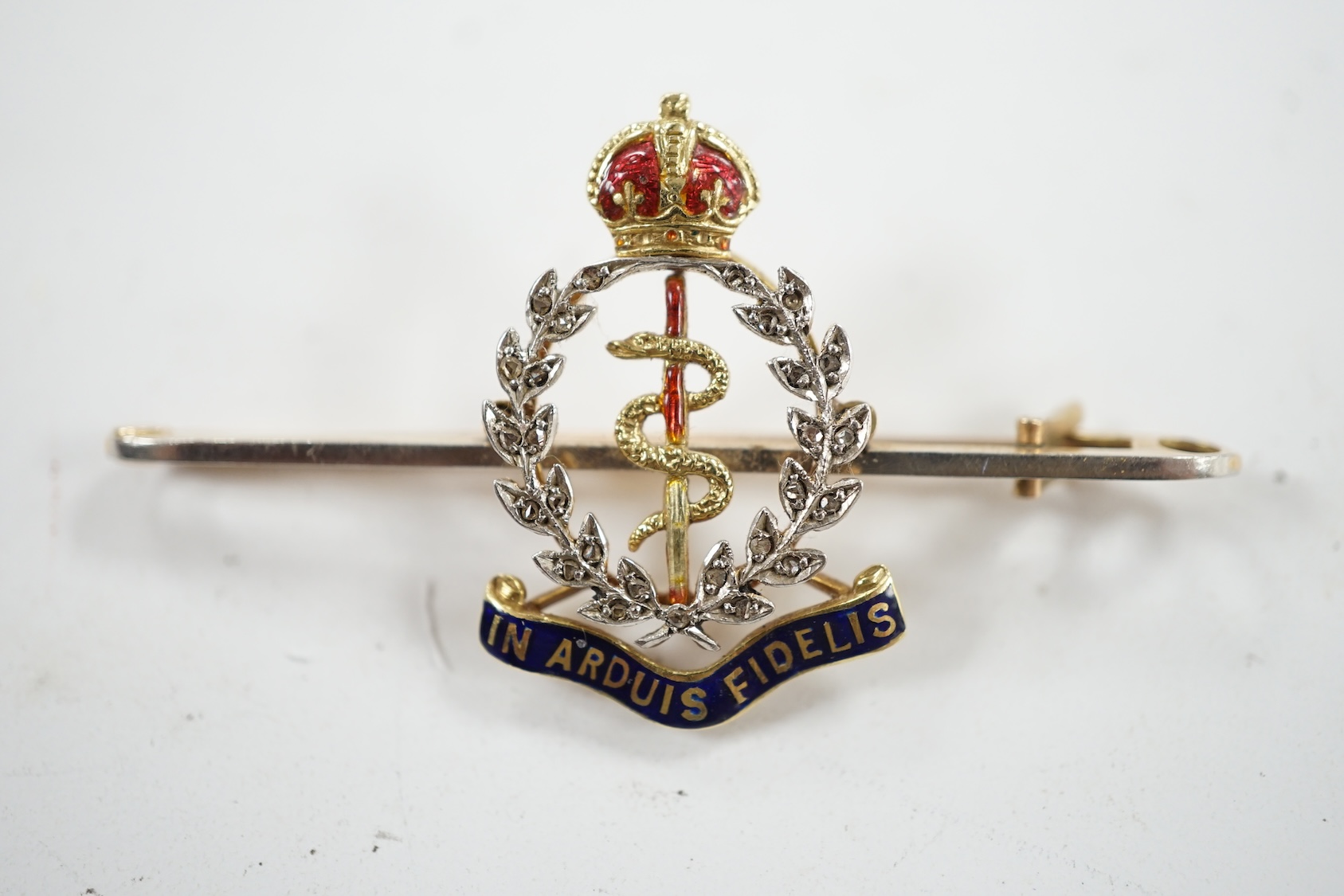 A mid 20th century 15ct, enamel and diamond set Royal Army Medical Corps sweethearts brooch, 49mm, gross weight 5 grams, in a Garrard & Co box. Condition - good